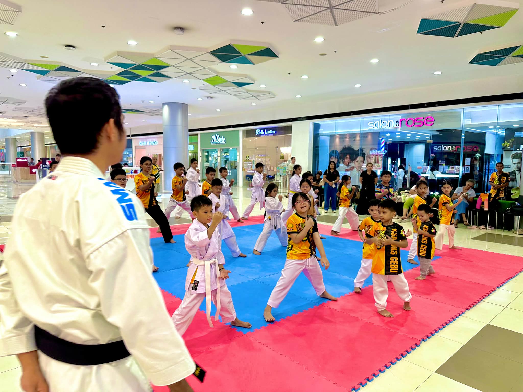 Karate students practicing basic stances with an instructor