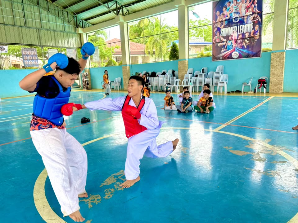 Two karate athletes sparring in protective gear